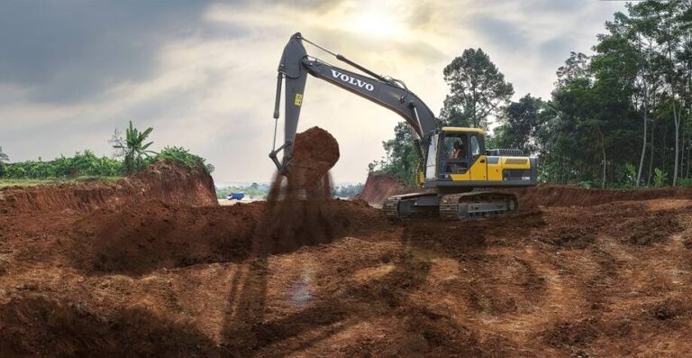 Crawler excavator digging a deep earth pit on a construction site