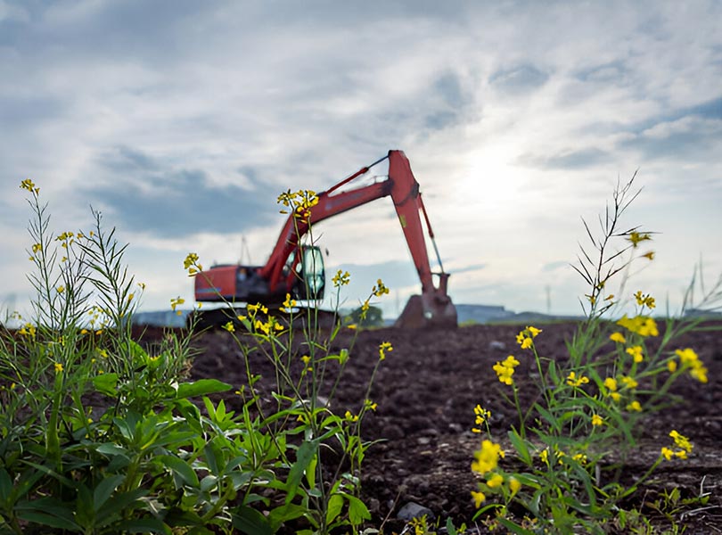 medium excavator working in the farm field