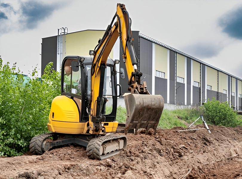 mini excavator grading land