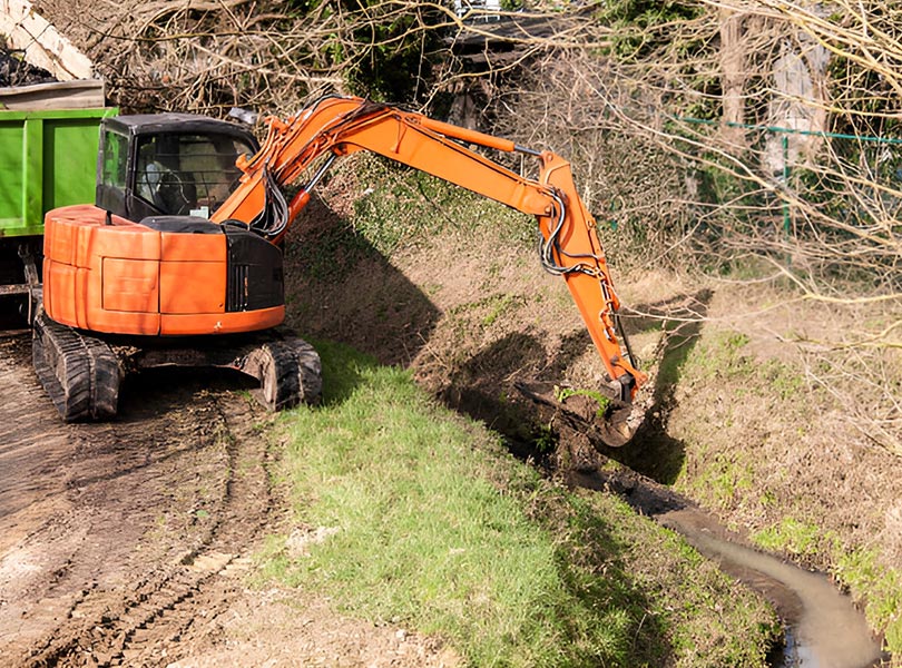small excavator digging trench for sewage